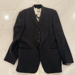 Black suit, white shirt dark multi colored tie